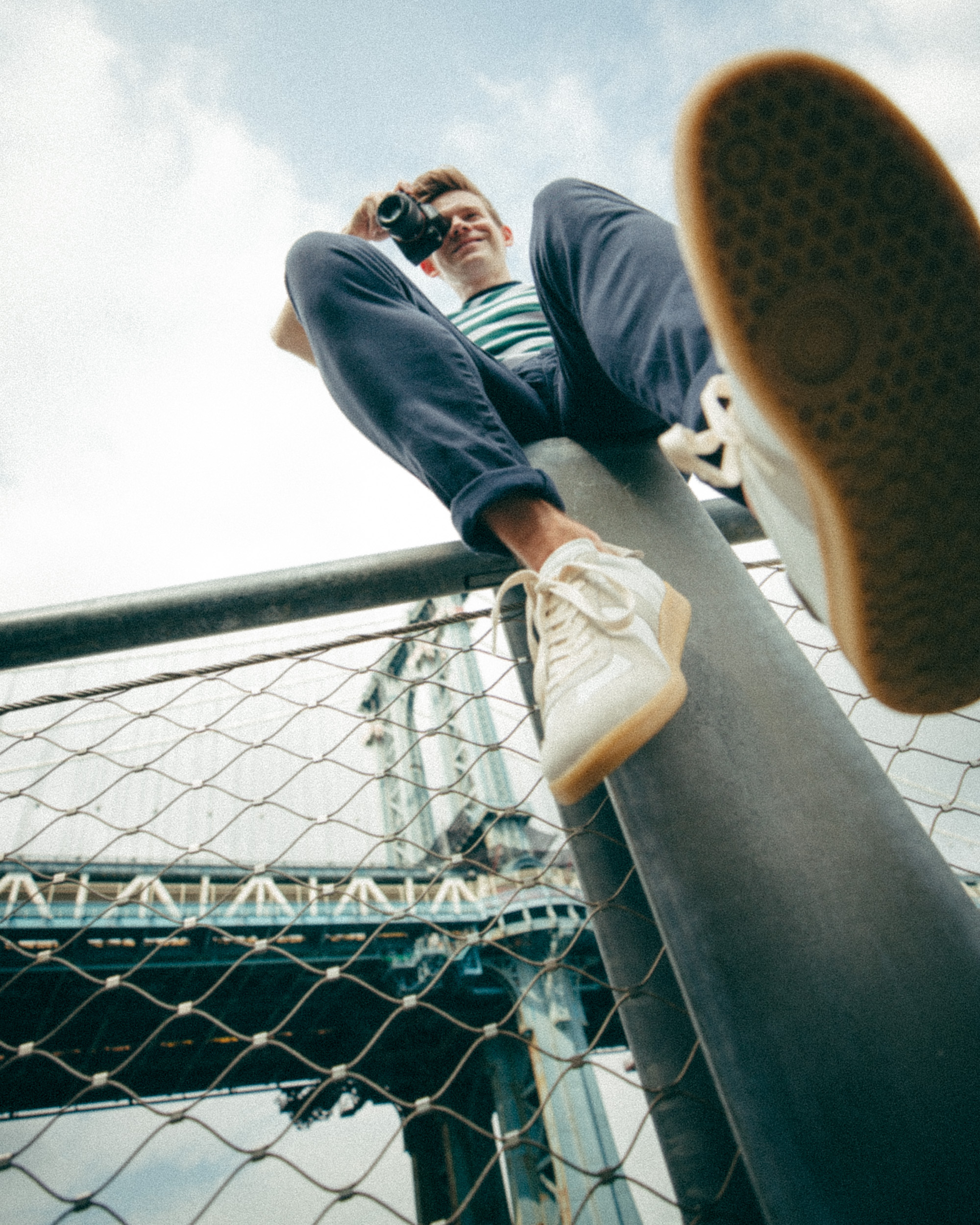 Andrew Keenan-Bolger photographing the Manhattan Bridge from a low angle